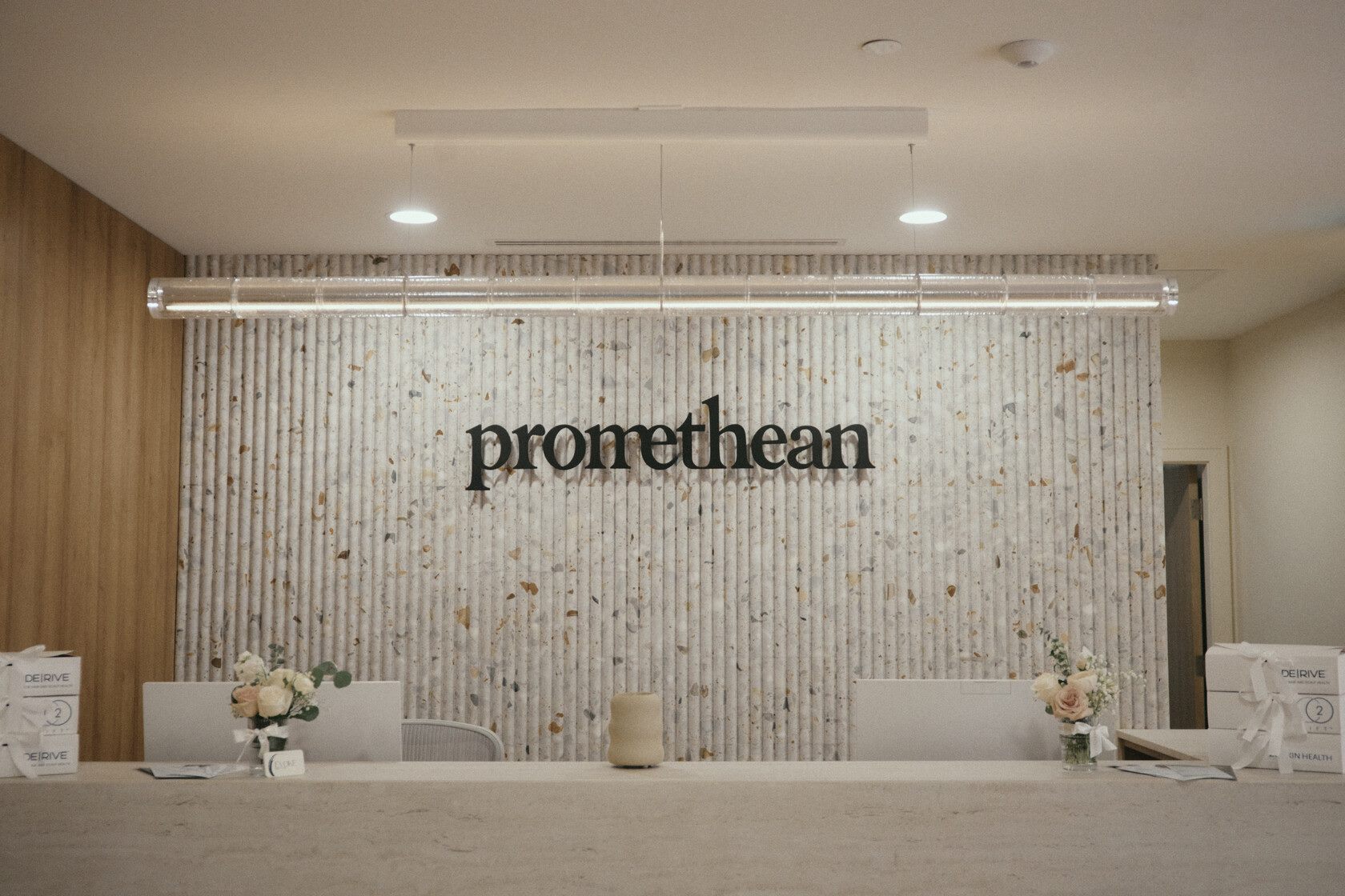 Reception desk and terrazzo feature wall at Promethean Clinic in downtown Vancouver